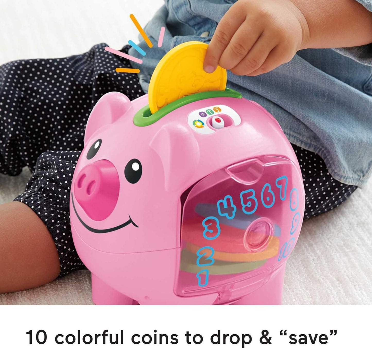 Child playing with Fisher-Price Smart Stages piggy bank toy, dropping colorful coins into the slot.